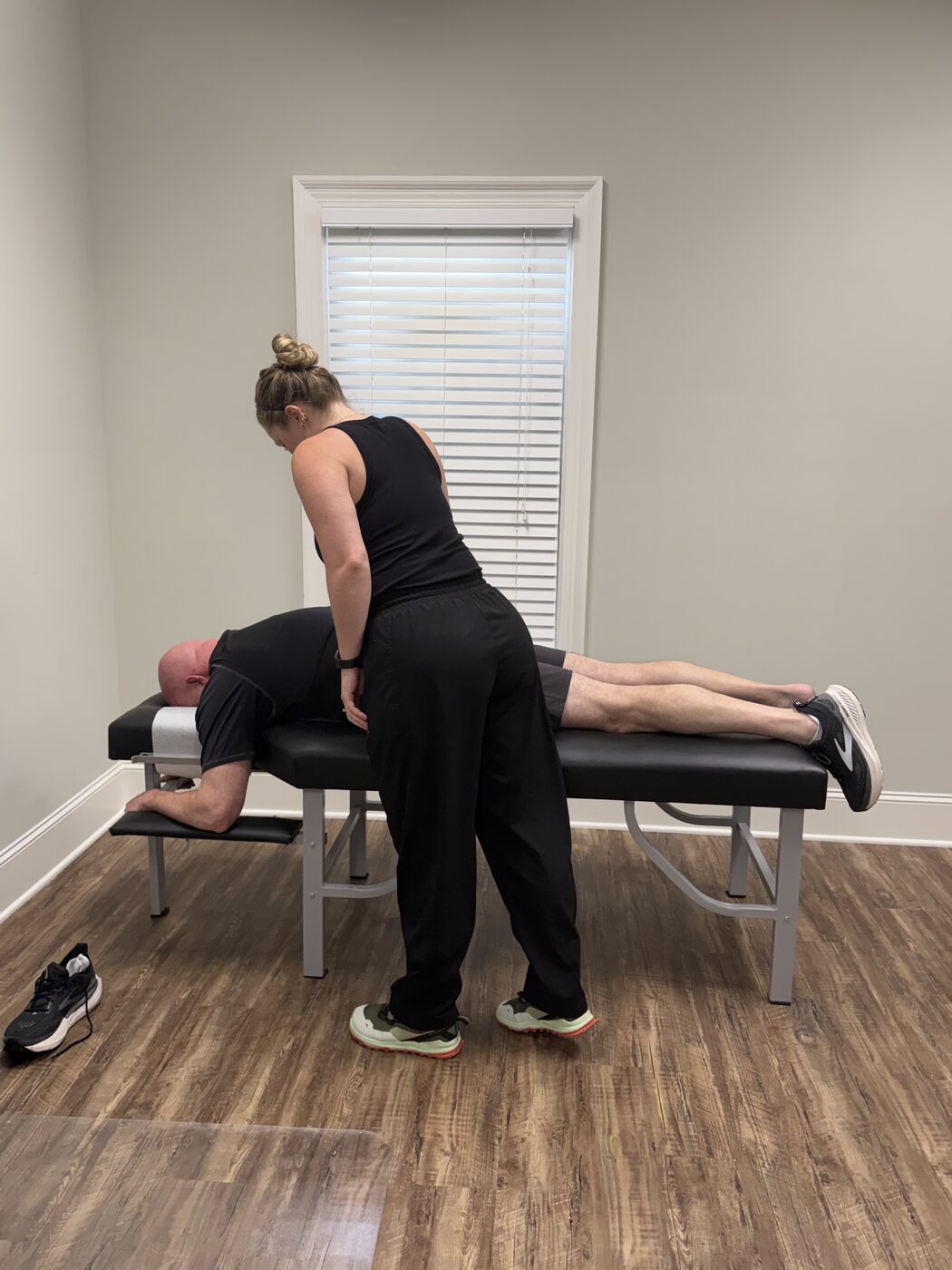 Dr. Corie Terwilliger performing a back adjustment on a patient at Georgia Spine and Sports Rehab