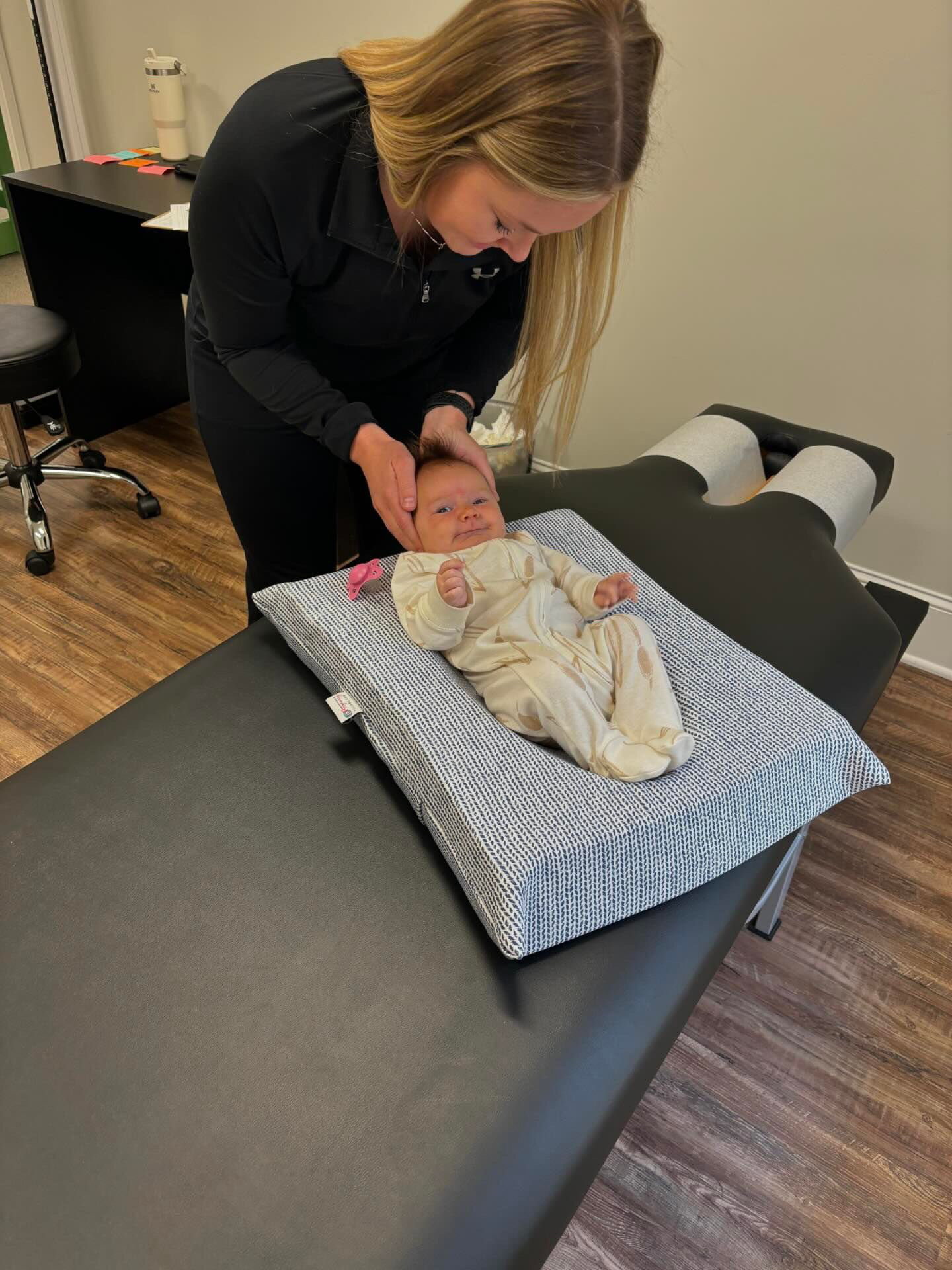Dr. Corie Terwilliger providing gentle cranial care for a newborn on a soft positioning cushion